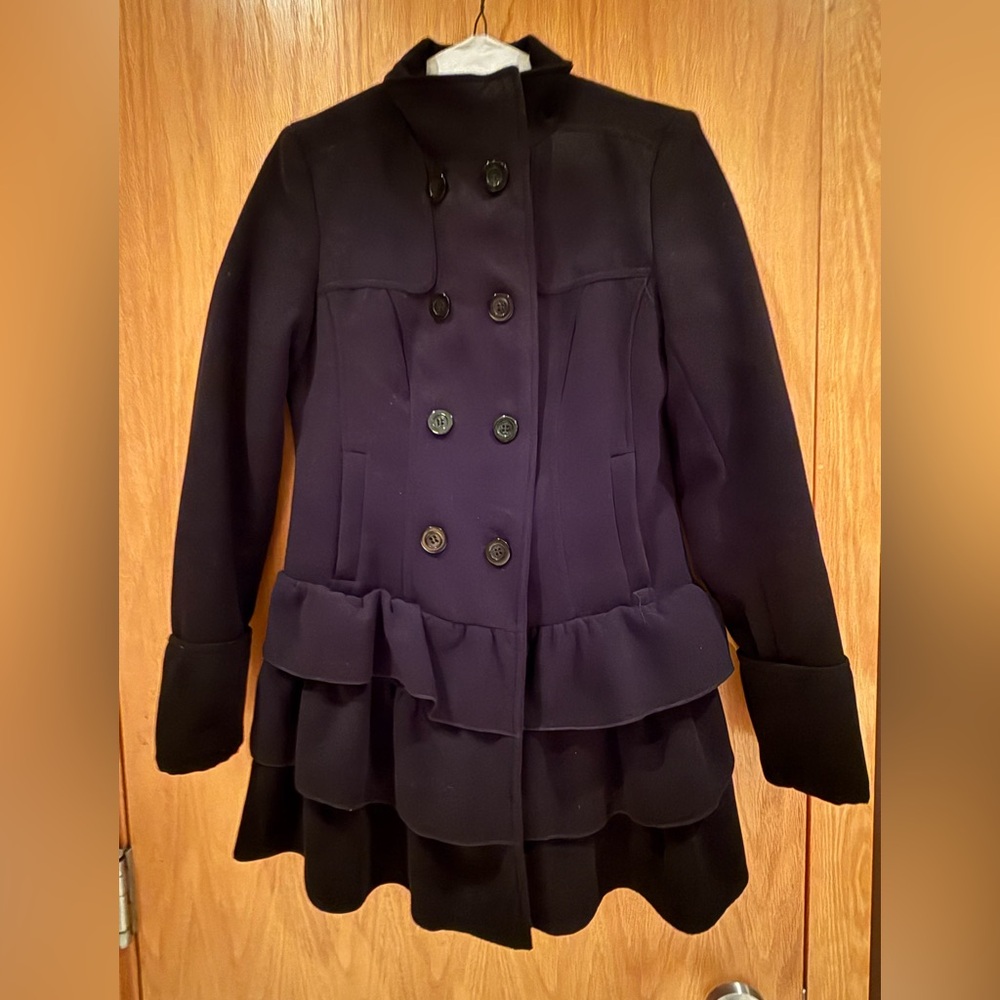 Girls black pea coat with cute ruffle detail.
